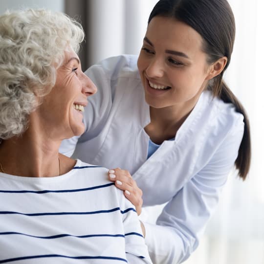 nurse looking at elderly woman